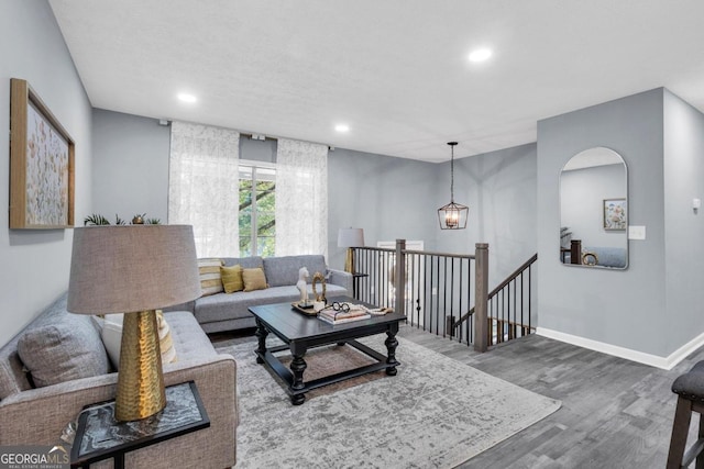 living room with hardwood / wood-style floors and a chandelier