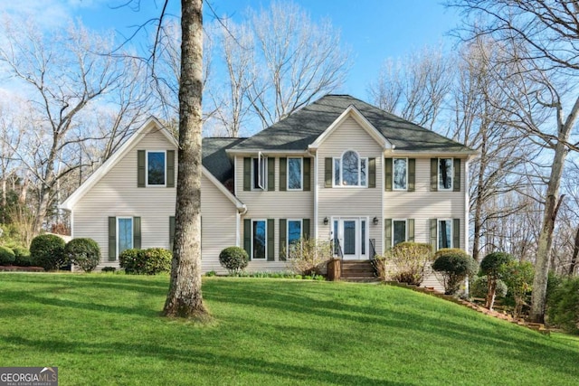 colonial inspired home with a front lawn