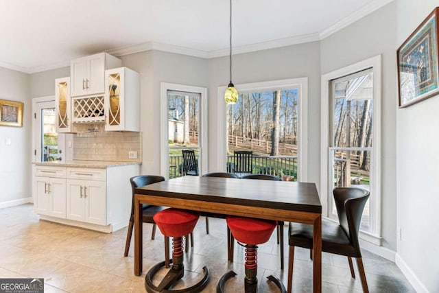 dining area featuring crown molding, plenty of natural light, and light tile patterned floors