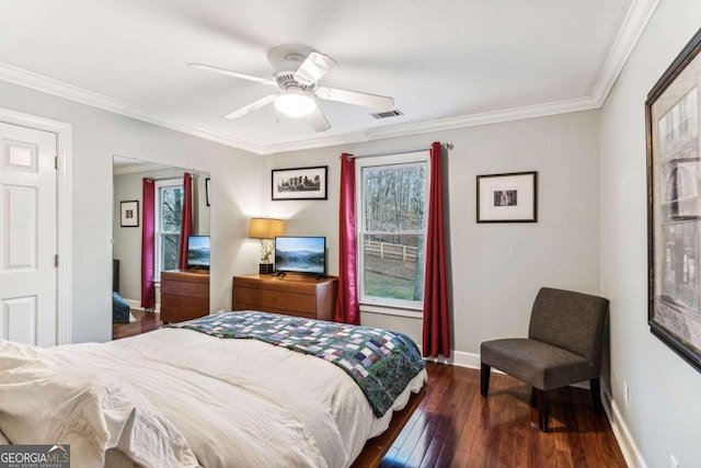 bedroom featuring dark hardwood / wood-style flooring, ornamental molding, and ceiling fan