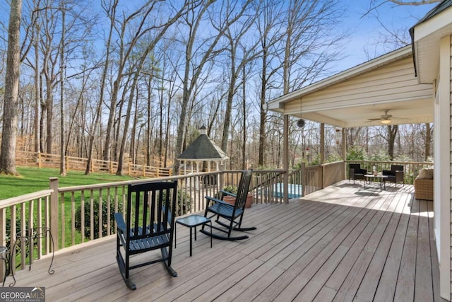 wooden terrace featuring ceiling fan