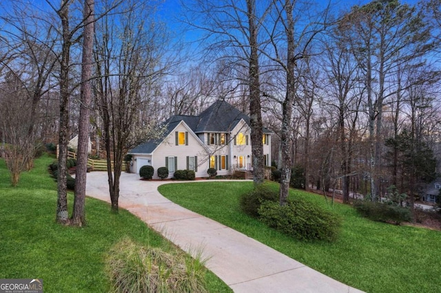 view of front of property featuring a front lawn and a garage