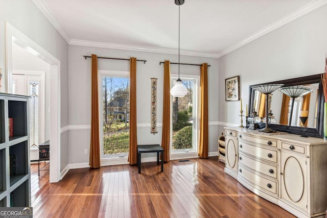 interior space featuring hardwood / wood-style flooring and ornamental molding