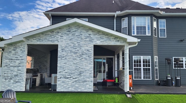 rear view of house with area for grilling and a patio area