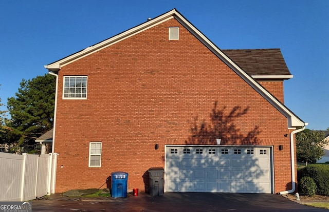 view of side of home featuring a garage