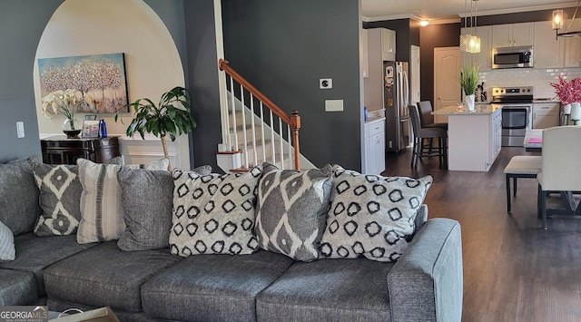 living room with dark hardwood / wood-style floors and ornamental molding