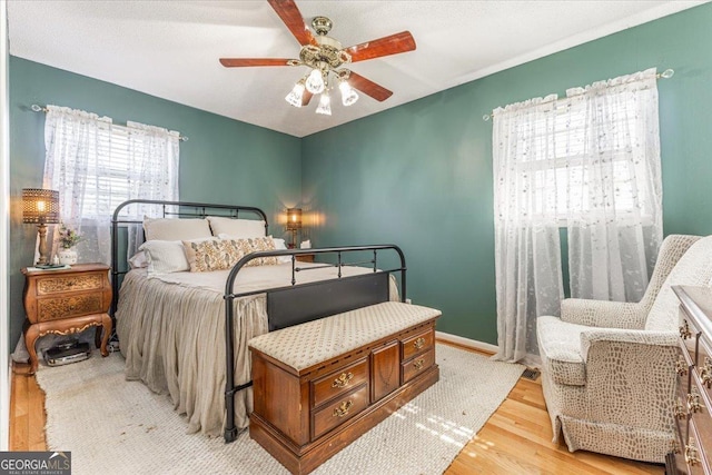 bedroom featuring ceiling fan and light wood-type flooring