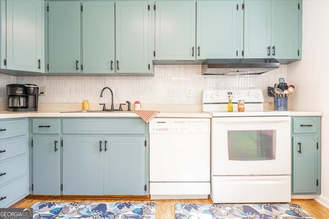 kitchen featuring sink, white appliances, light hardwood / wood-style flooring, range hood, and tasteful backsplash