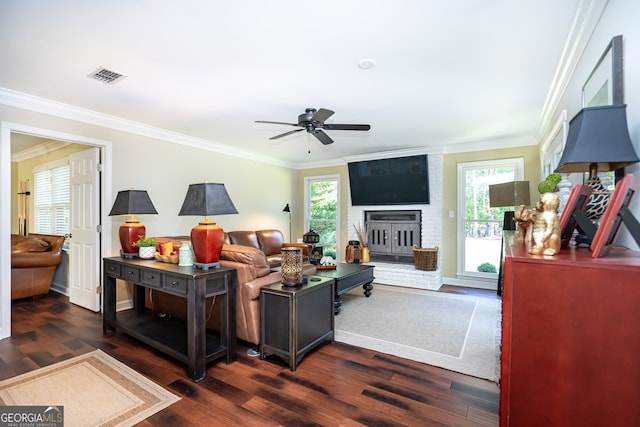 living room featuring plenty of natural light, ornamental molding, and dark hardwood / wood-style flooring