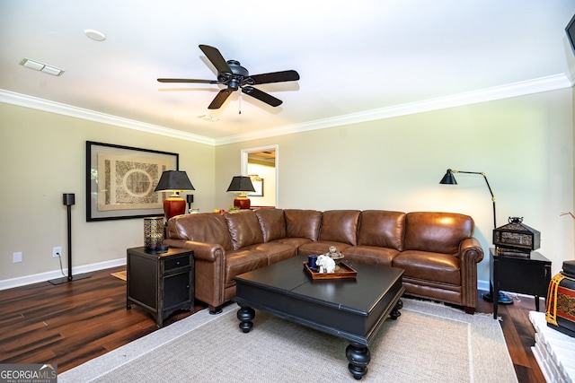 living room with dark wood-type flooring, crown molding, and ceiling fan