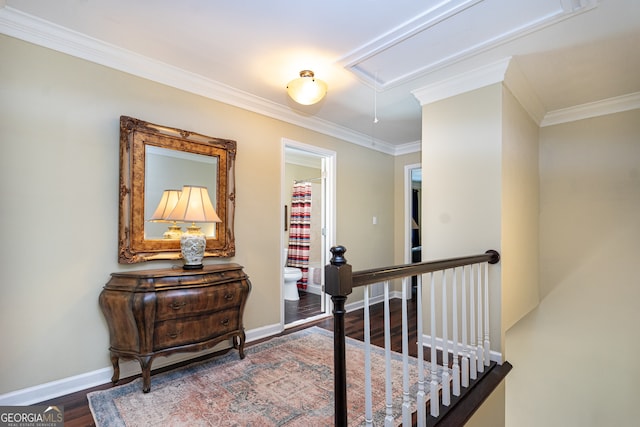 hall with dark wood-type flooring and crown molding