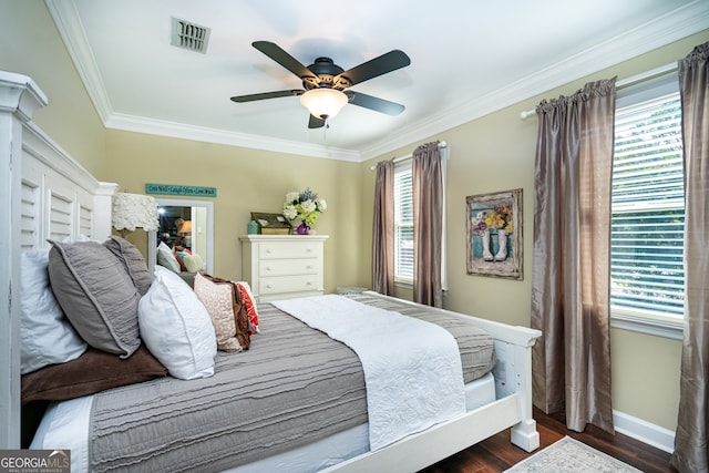 bedroom with dark hardwood / wood-style floors, ornamental molding, multiple windows, and ceiling fan