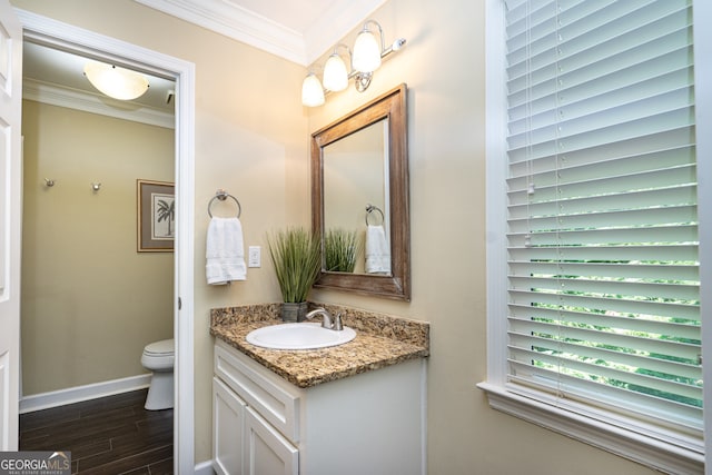 bathroom featuring ornamental molding, vanity, toilet, and hardwood / wood-style flooring