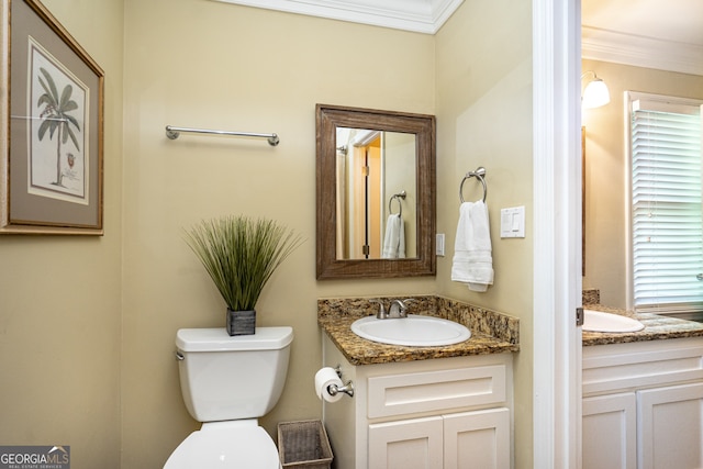 bathroom featuring crown molding, vanity, and toilet