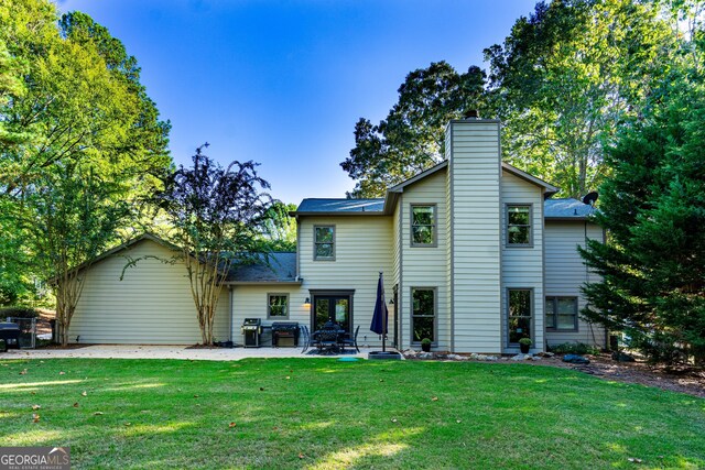 back of property featuring a patio and a yard