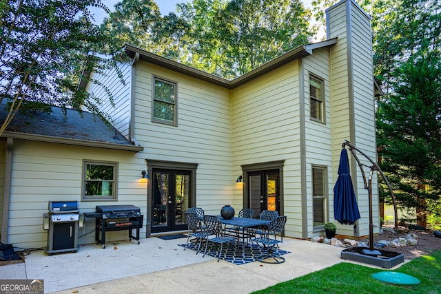 rear view of house with french doors and a patio area