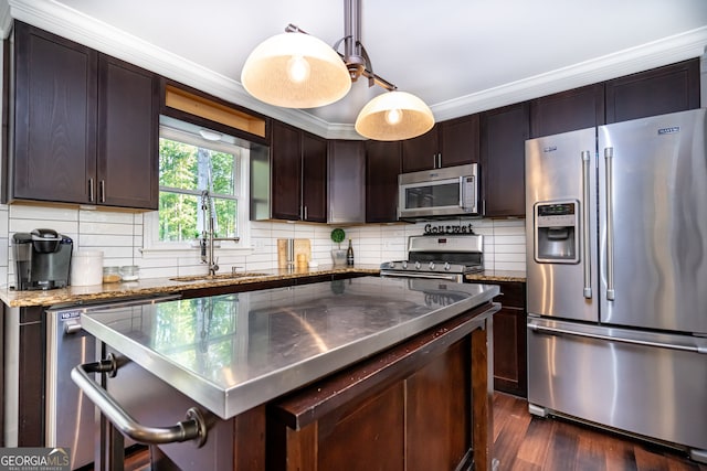 kitchen with stainless steel appliances, dark wood-type flooring, sink, dark brown cabinets, and backsplash