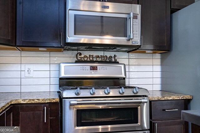 kitchen featuring dark brown cabinets, light stone counters, decorative backsplash, and stainless steel appliances