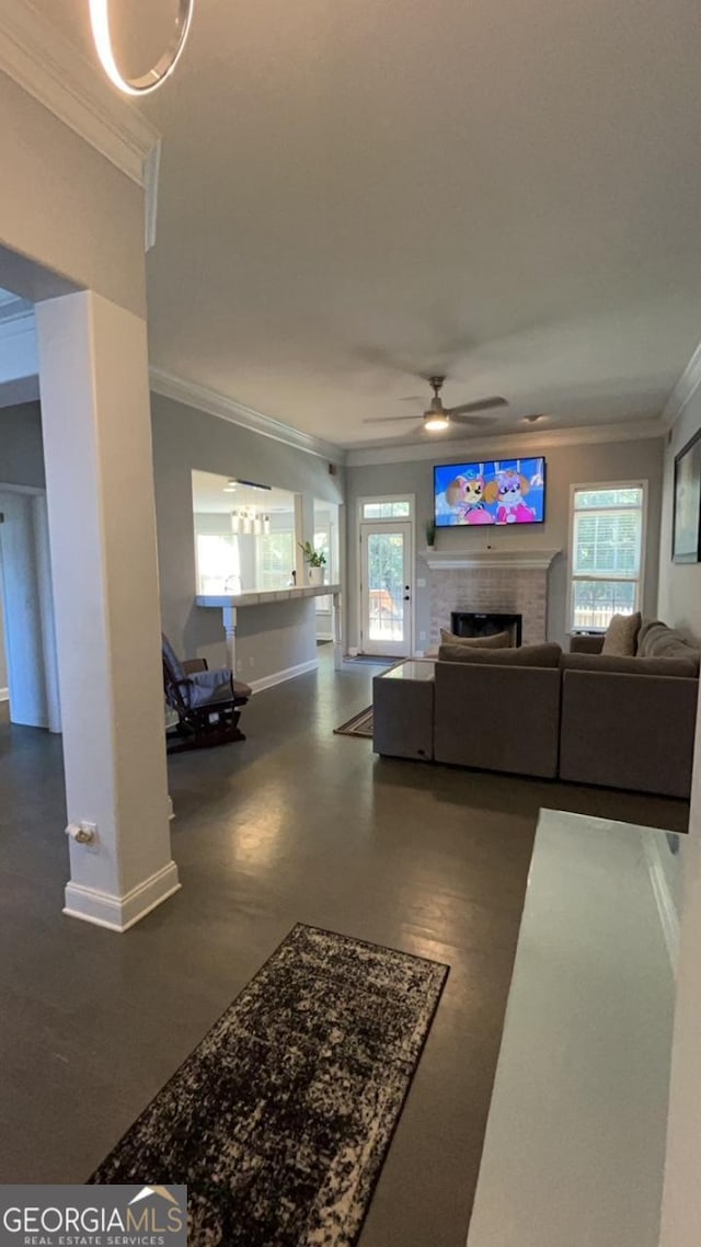 living room with a fireplace, ceiling fan, plenty of natural light, and ornamental molding