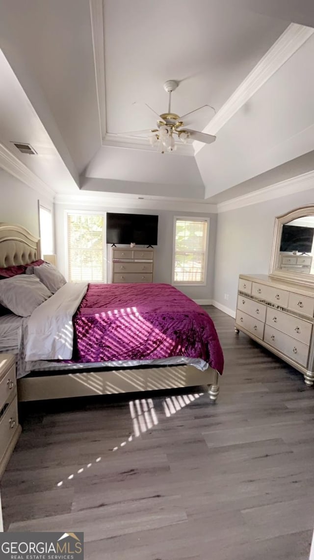 bedroom featuring hardwood / wood-style flooring, ceiling fan, and crown molding