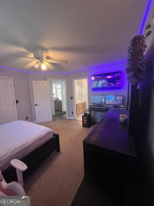 carpeted bedroom with ceiling fan and connected bathroom