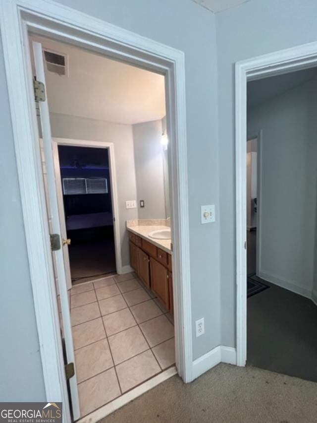 bathroom with tile patterned flooring and vanity