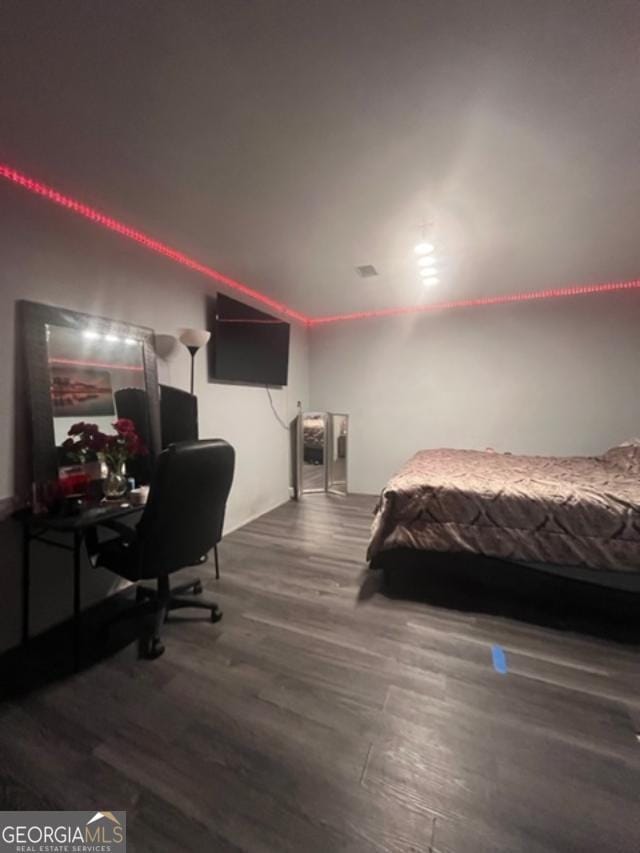 bedroom with dark hardwood / wood-style flooring