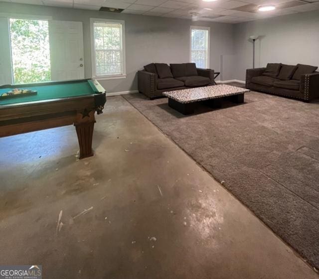 recreation room with a drop ceiling, concrete flooring, and billiards