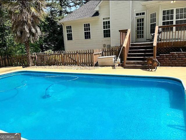 view of pool with a wooden deck