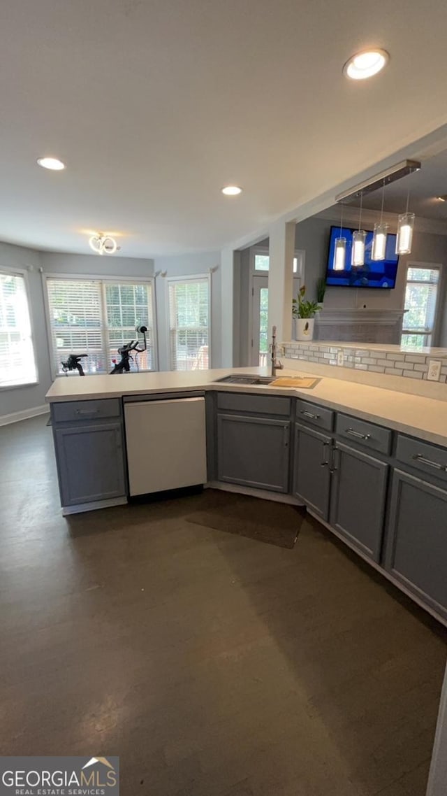 kitchen with dishwasher, gray cabinets, sink, and a wealth of natural light