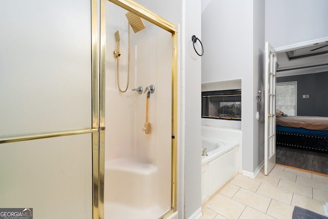 bathroom featuring tile patterned flooring and separate shower and tub