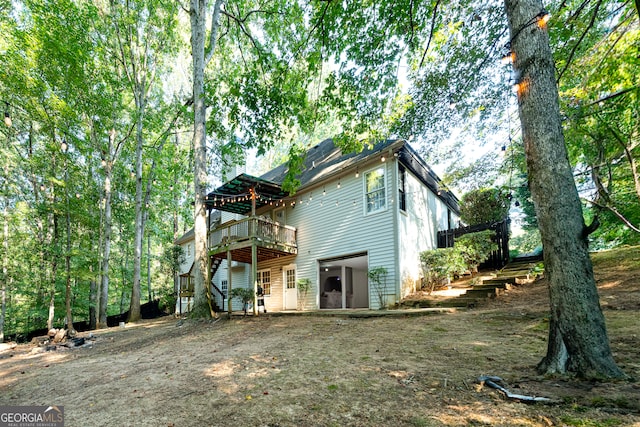 back of house featuring a deck