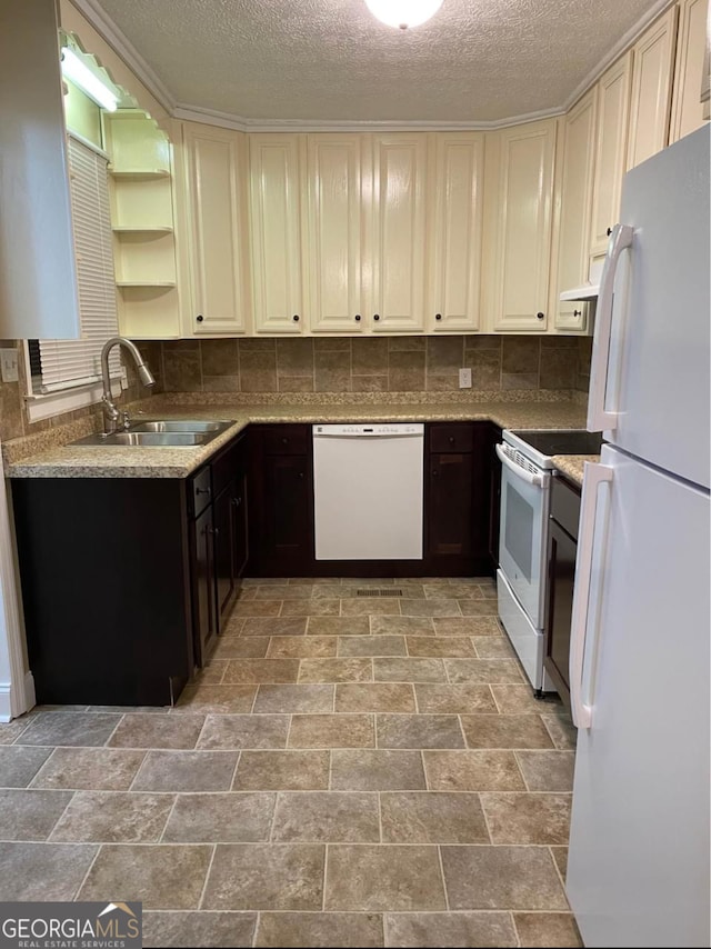 kitchen with dark brown cabinets, a textured ceiling, sink, and white appliances