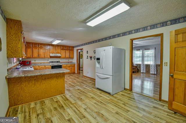 kitchen with white appliances, light hardwood / wood-style flooring, sink, kitchen peninsula, and a textured ceiling