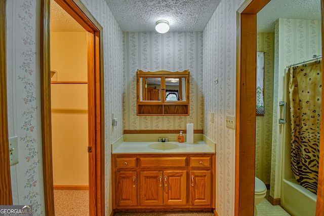 full bathroom with vanity, toilet, shower / bathtub combination with curtain, and a textured ceiling