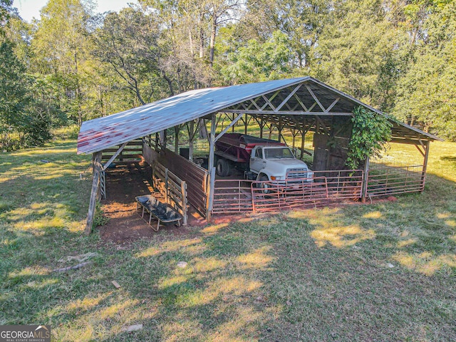 view of outbuilding with a yard and a carport