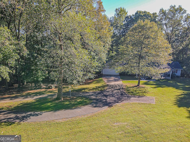 exterior space with a yard and a garage