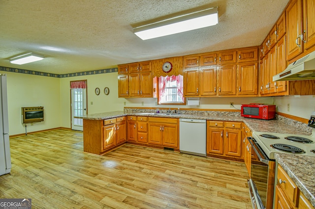 kitchen featuring white appliances, light hardwood / wood-style floors, heating unit, kitchen peninsula, and a textured ceiling