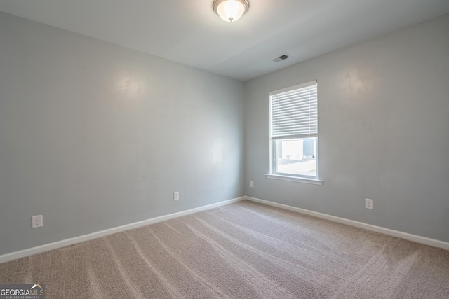 empty room featuring light carpet