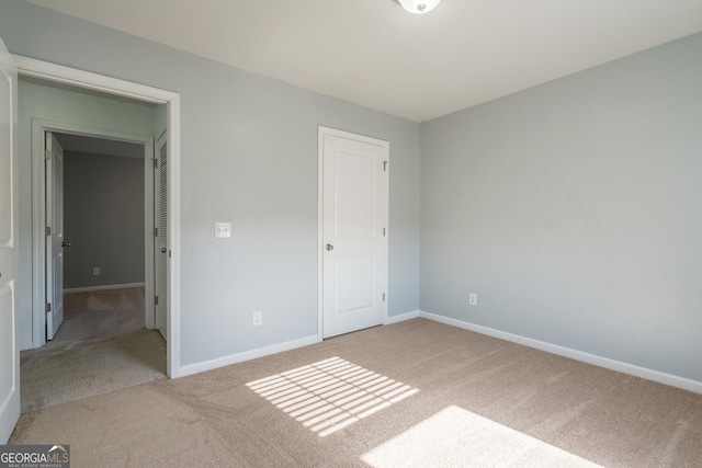 unfurnished bedroom featuring light colored carpet