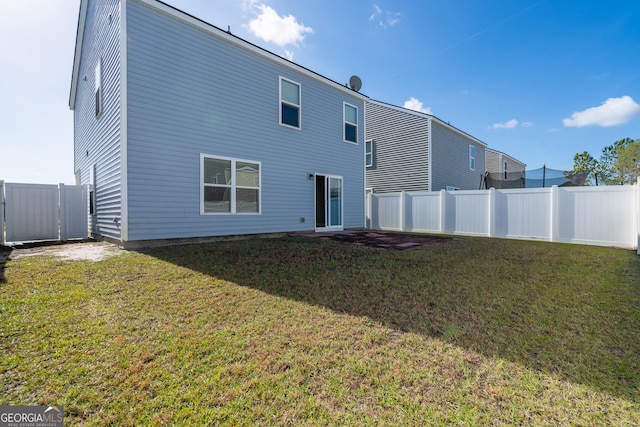 rear view of house featuring a lawn