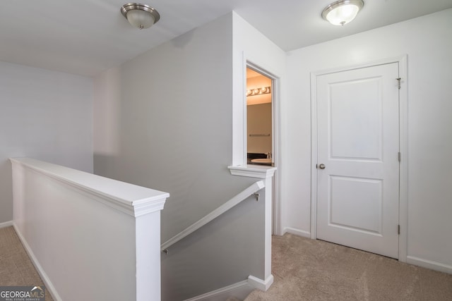 hallway with light colored carpet