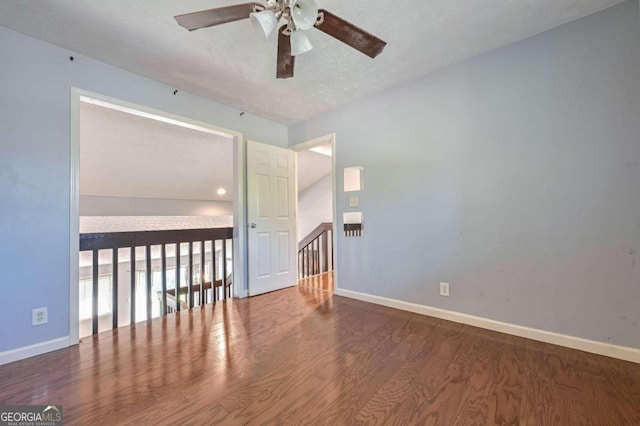 empty room featuring ceiling fan, hardwood / wood-style flooring, and a textured ceiling