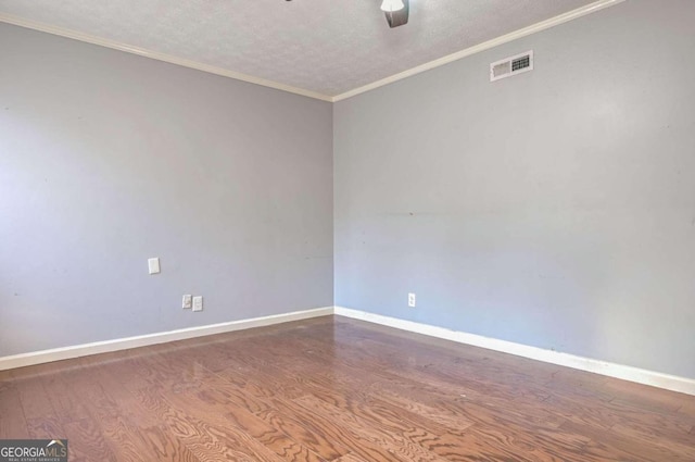 spare room with ornamental molding, hardwood / wood-style flooring, ceiling fan, and a textured ceiling