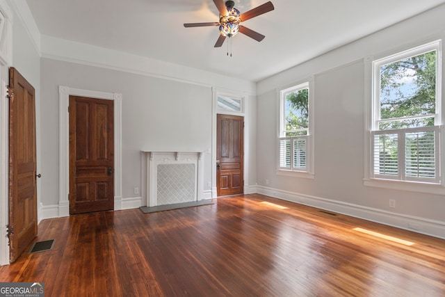 spare room featuring dark hardwood / wood-style flooring, a wealth of natural light, and ceiling fan