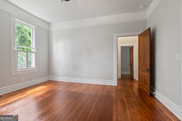 spare room with dark hardwood / wood-style flooring