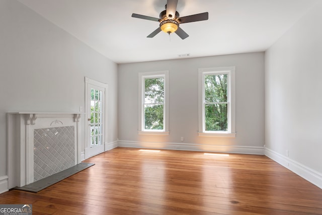 unfurnished living room featuring ceiling fan and light hardwood / wood-style floors