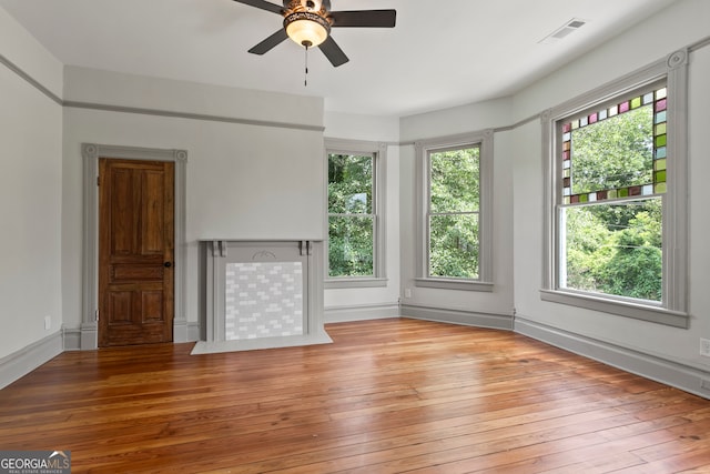 unfurnished living room featuring ceiling fan and light hardwood / wood-style floors