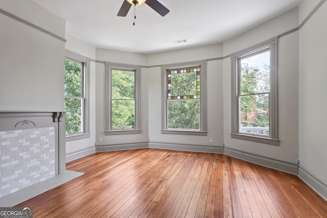 interior space featuring ceiling fan, a wealth of natural light, and light hardwood / wood-style floors