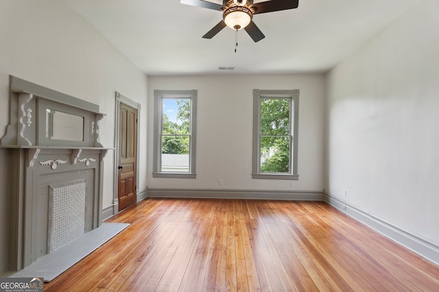 unfurnished living room with light hardwood / wood-style flooring and ceiling fan